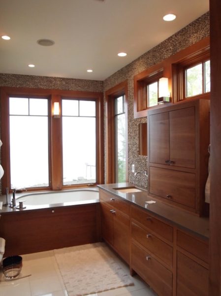 A spa bathroom with wooden cabinets and a tub.