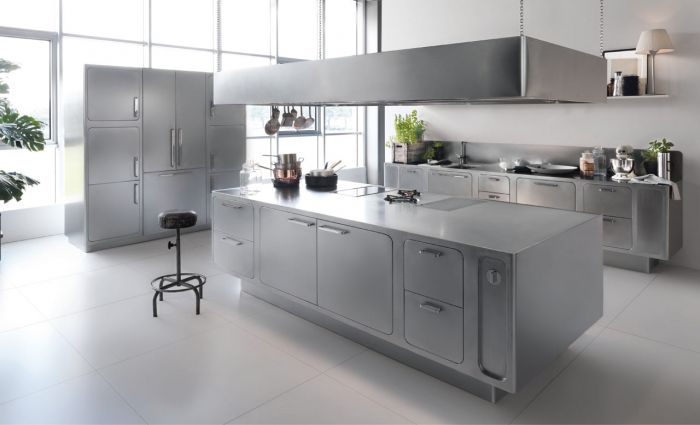 A modern kitchen with stainless steel surfaces and appliances.