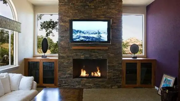Living room with fireplace and mounted television.