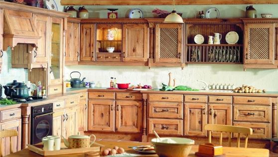 A kitchen with wooden cabinets and a table.