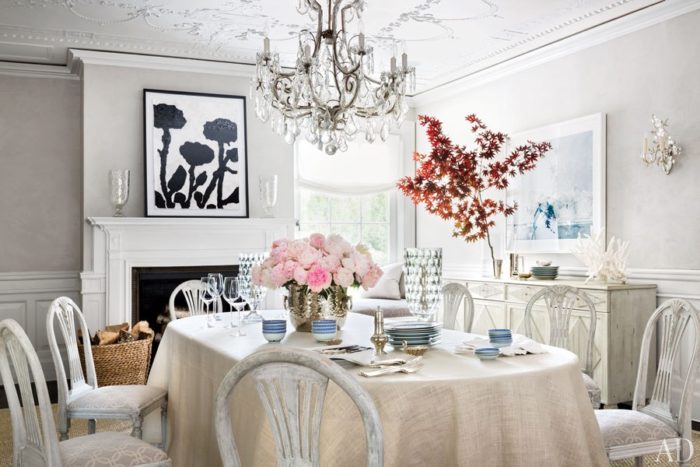 A tranquil sanctuary with white chairs and a chandelier.