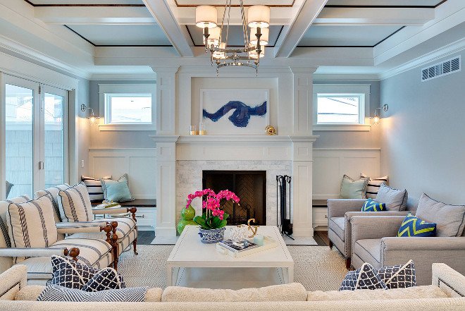 A sanctuary-like living room with white furniture and a blue fireplace.