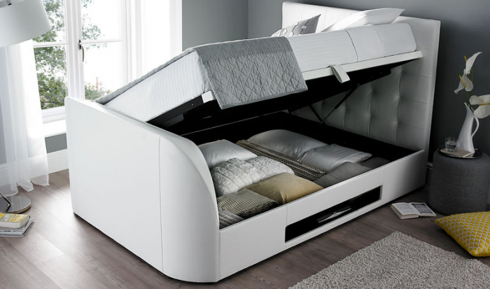 A white bed with a storage compartment in it.