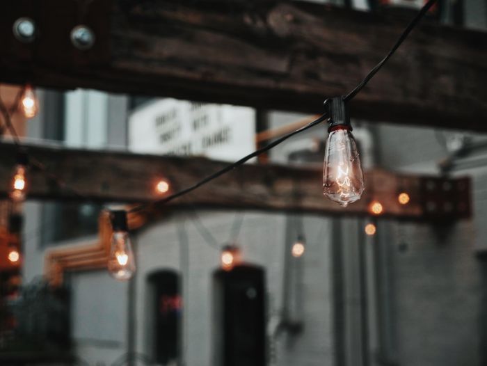 A string of light bulbs decorating a patio.