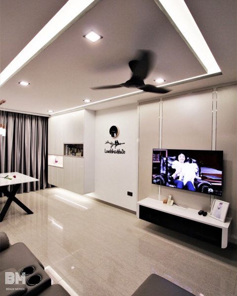 A modern living room with a flat screen tv in a small living space.