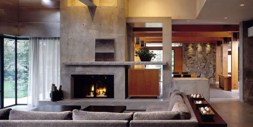 Modern living room with fireplace and concrete accents.