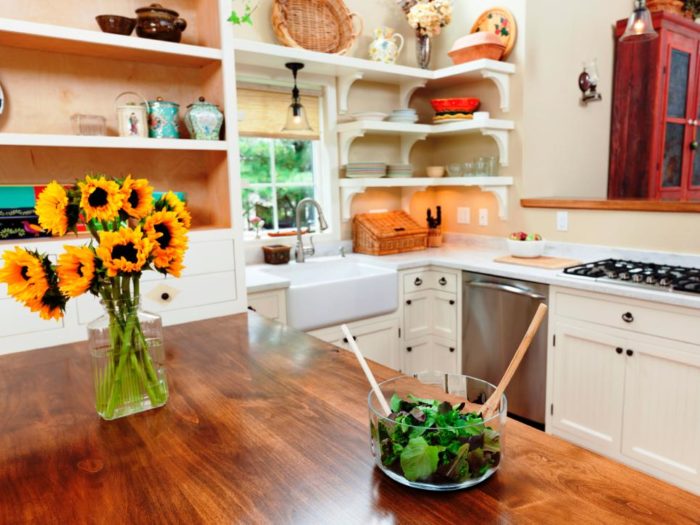 A wooden kitchen counter with sunflowers in a vase, perfect for the best cheap kitchen.