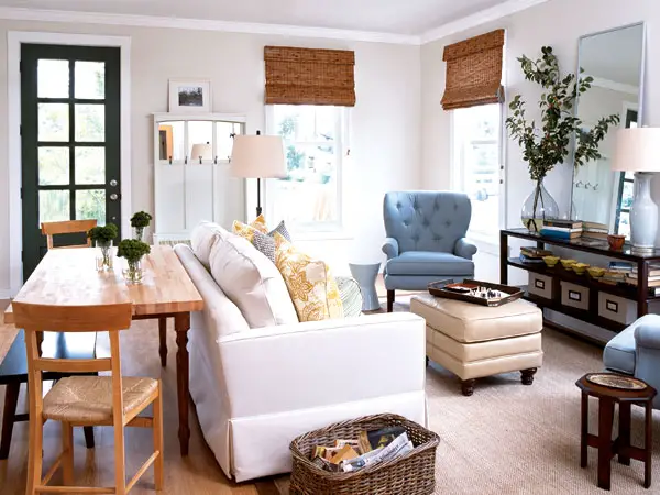 An interior design featuring a living room with white furniture and blue accents.