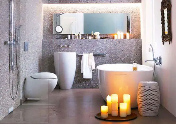 Modern bathroom interior with candles and freestanding tub.
