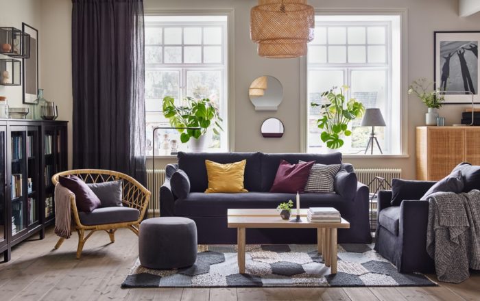A black couch and yellow coffee table in a living room.