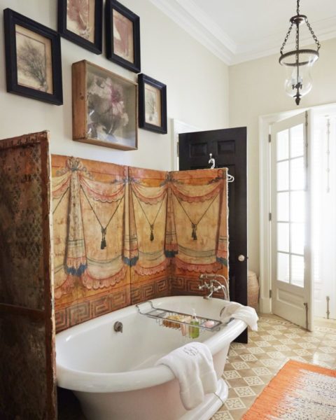 An orange-rug bathroom with framed pictures, showcasing interior designing.