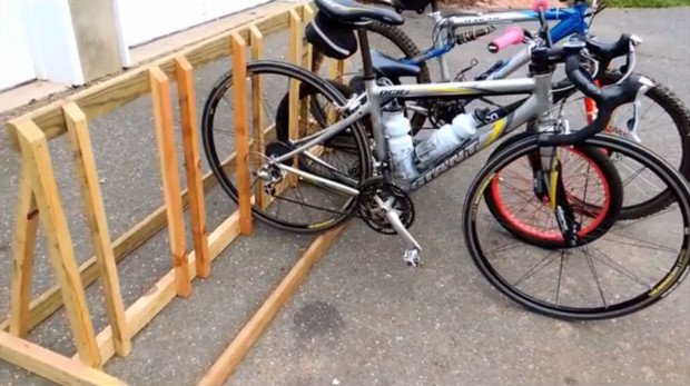 Two bicycles are next to each other in a garage, a fixture.
