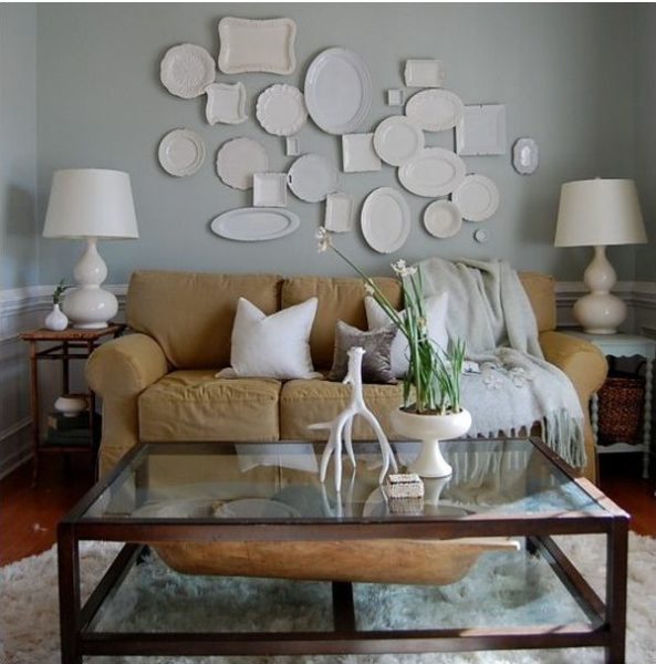 A visually stunning living room adorned with a plethora of plates on the wall, showcasing exquisite interior designing.