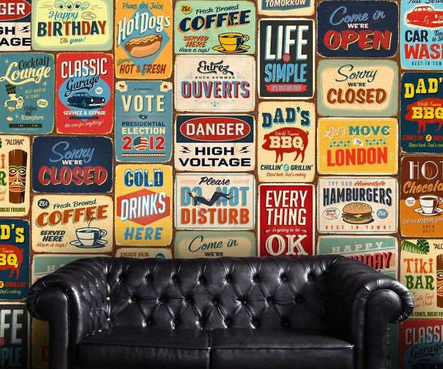 A dull living room with many different signs on the wall.