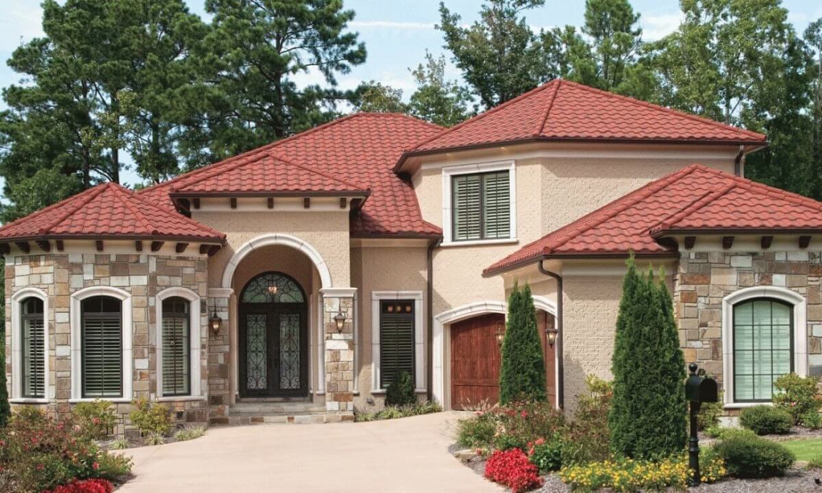 Mediterranean style home with red tile roof featuring unconventional roofing ideas.