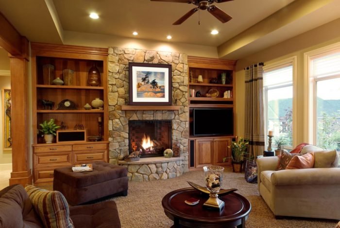 A cozy living room with a stone fireplace.