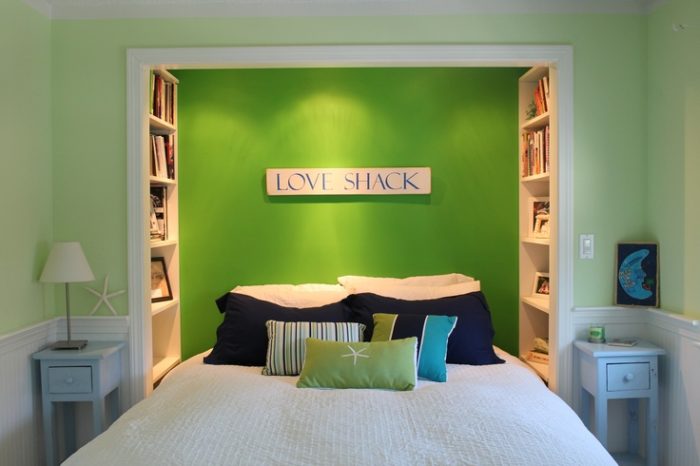 A creatively designed bedroom with a bed and bookshelves.