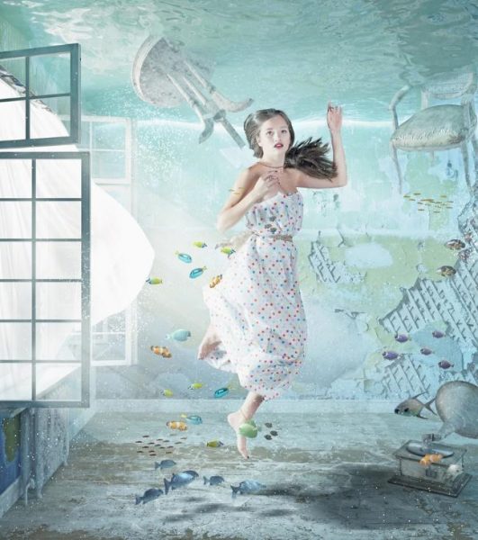 A girl in a dress is floating in the water during a Home Maintenance session.