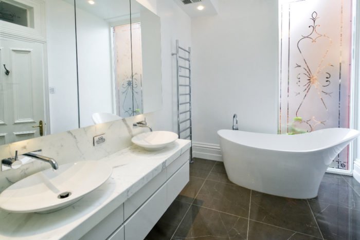 A stylish bathroom with two sinks and a bathtub.