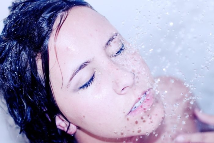 A woman is taking a shower, embracing beauty.