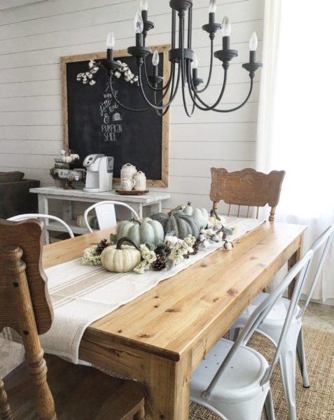 A fresh fall decorating idea featuring a dining room table adorned with pumpkins and a chalkboard.
