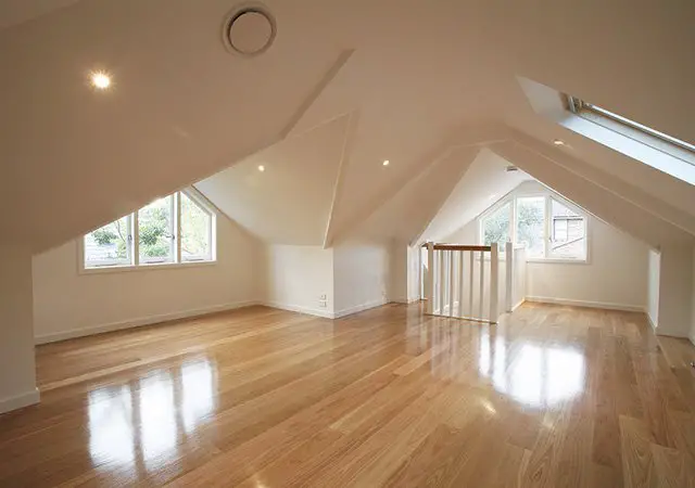 A creatively designed room with hardwood floors and a skylight.