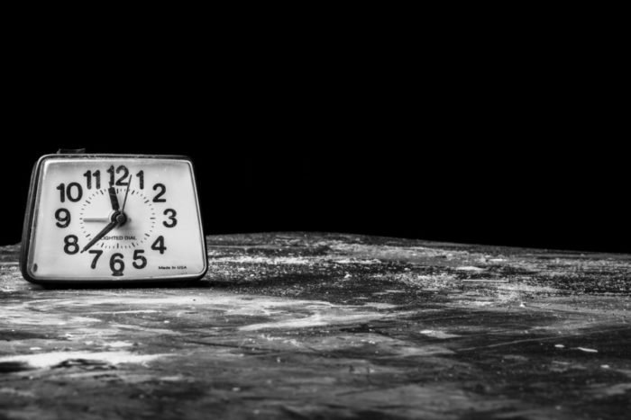 A black and white photograph of a clock on the moon, showcasing lunar beauty.