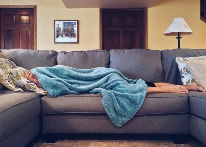 A person experiencing beauty sleep on a couch.