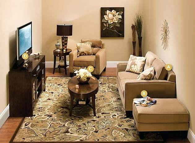 A small living space with a tan rug and a tv.