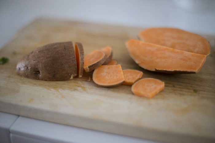 Sweet potatoes on a cutting board - glowing skin stock videos & royalty-free footage.