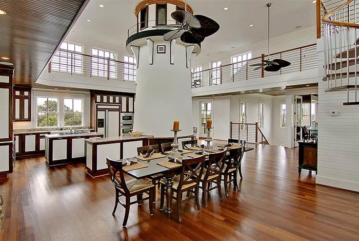 A spacious lighthouse home featuring a large kitchen and dining room with a spiral staircase.