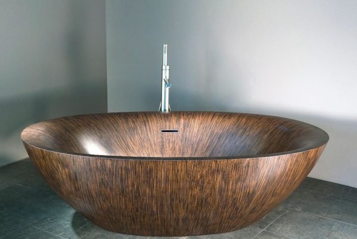 A stylish wooden bathtub sitting in a room.