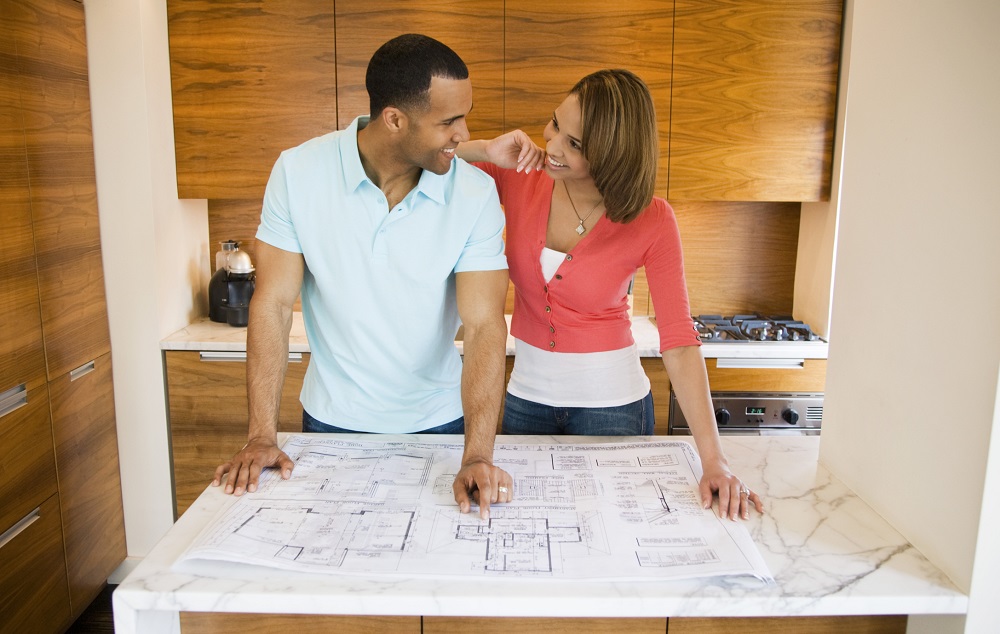 A man and woman planning a realistic extreme home makeover.