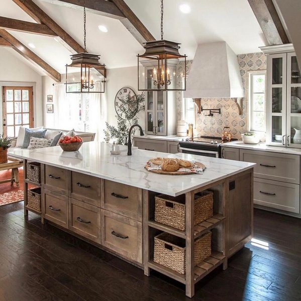 A vintage kitchen with wooden beams and a large island.