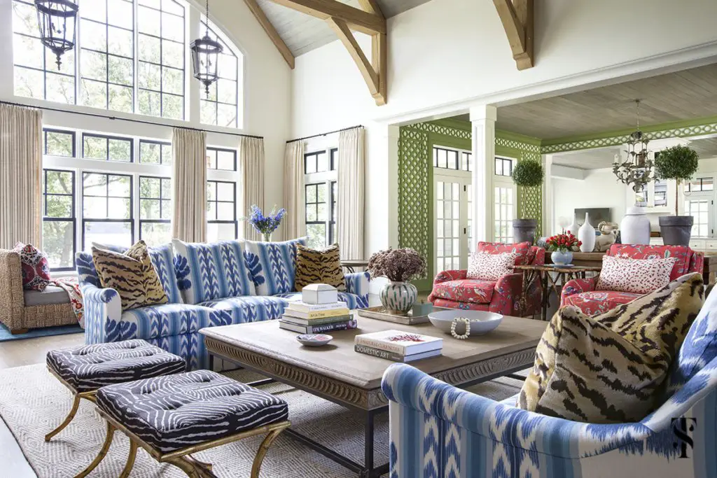 A living room with blue and green patterned furniture designed by Summer Thornton.