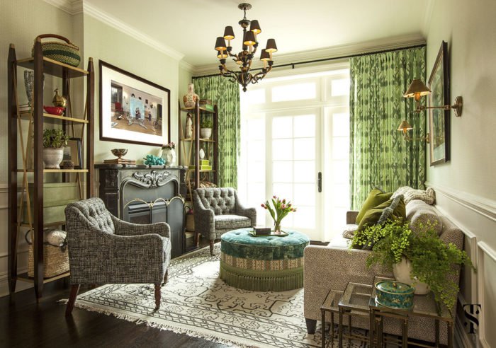 A living room with green curtains designed by Summer Thornton.