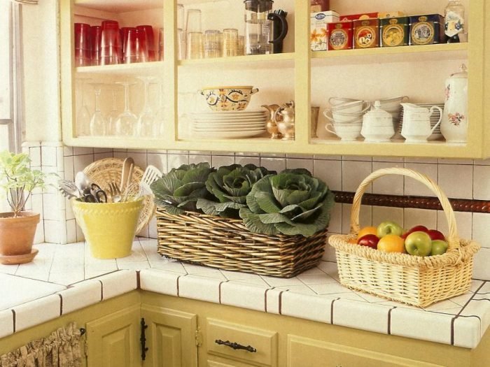 A small kitchen with yellow cabinets.