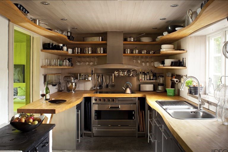 Small kitchen ideas with wooden shelves and a stove.