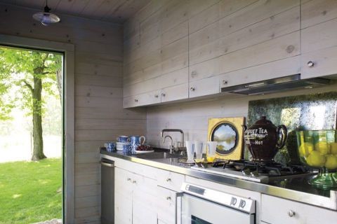 A small kitchen with wooden cabinets and a door to the outside, perfect for small kitchen ideas.