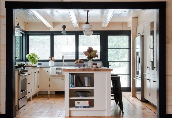Small kitchen with a white cabinets and a black island.