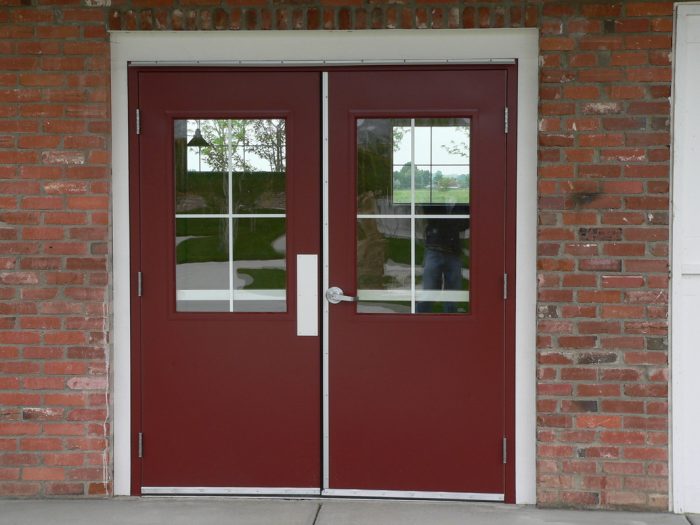 A double door with a glass window suitable for residential and commercial use.