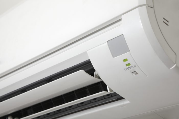 A close up image of a white air conditioner used for service.