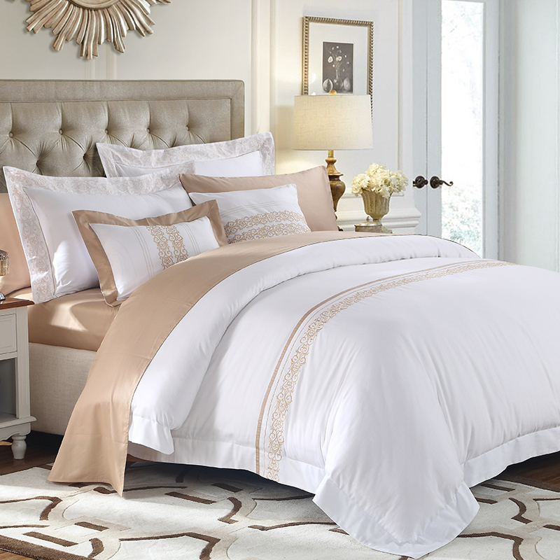 New bed set with a white and beige comforter.