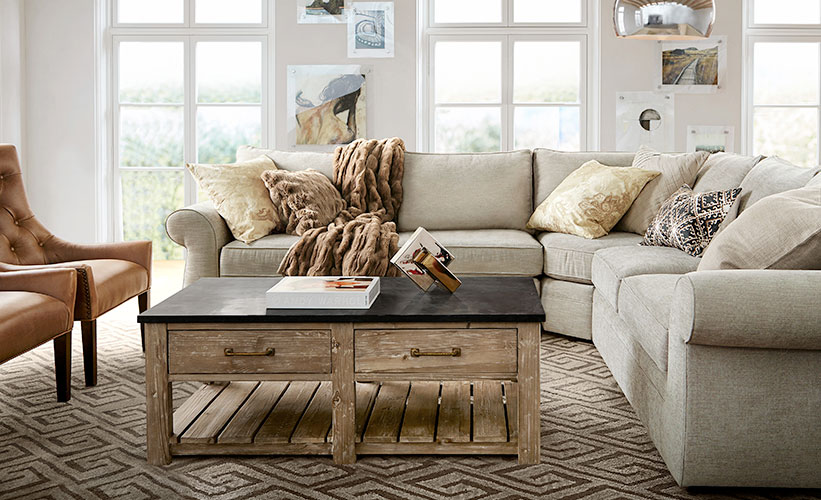 A living room featuring a sectional couch and coffee table, providing tips on choosing the perfect furniture.