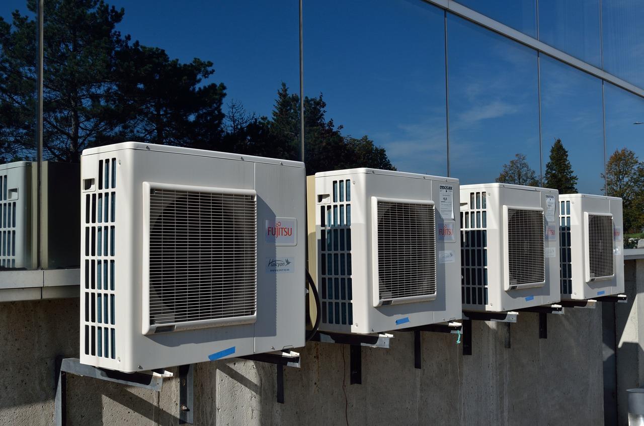A row of air conditioners installed on a building, highlighting the importance of proper care.