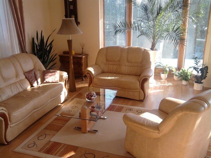 A living room with tan furniture and a coffee table that is wheelchair accessible.