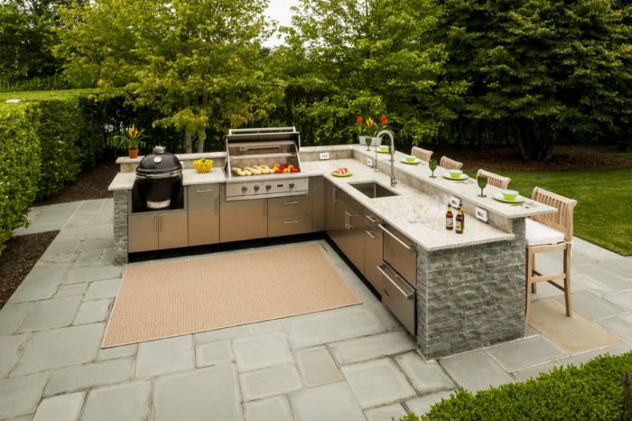 An outdoor kitchen with a fantastic grill and sink using stamped concrete.