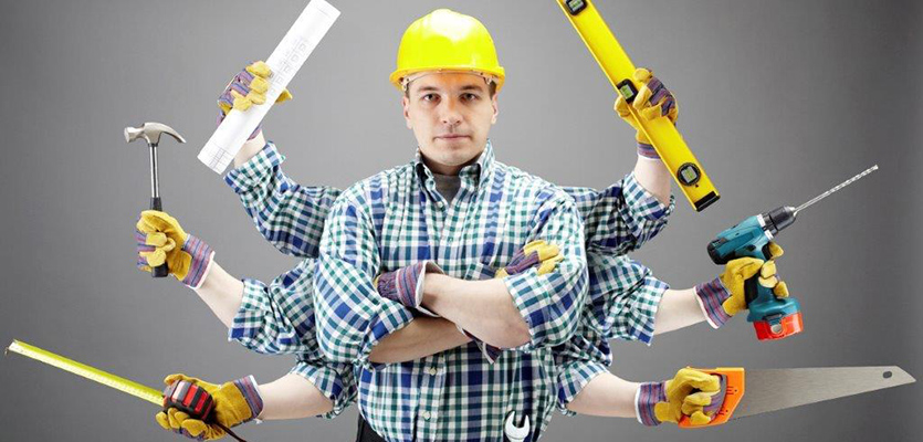 A Tradesman holding tools in his hands.