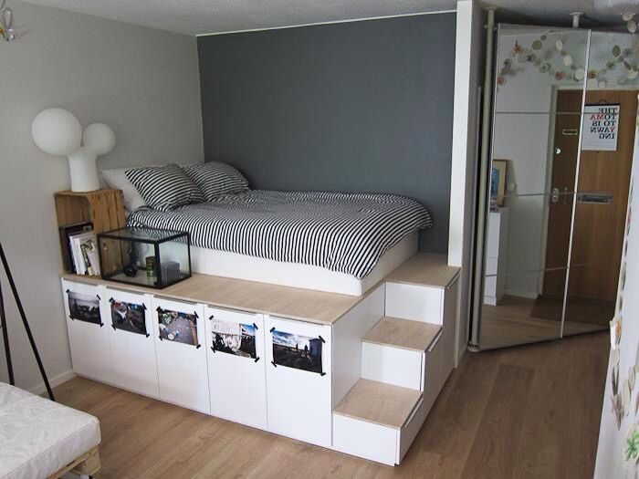 A small bedroom with a bed and a desk, lacking storage space.