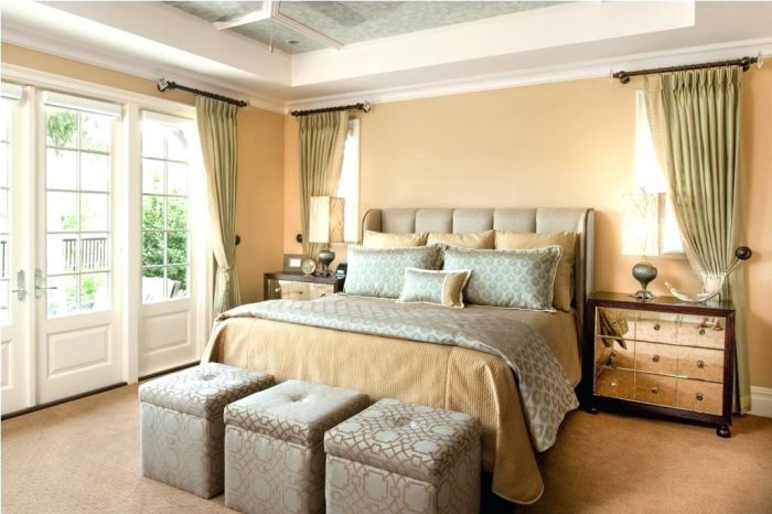 A bedroom with beige walls, furniture and the right bed.